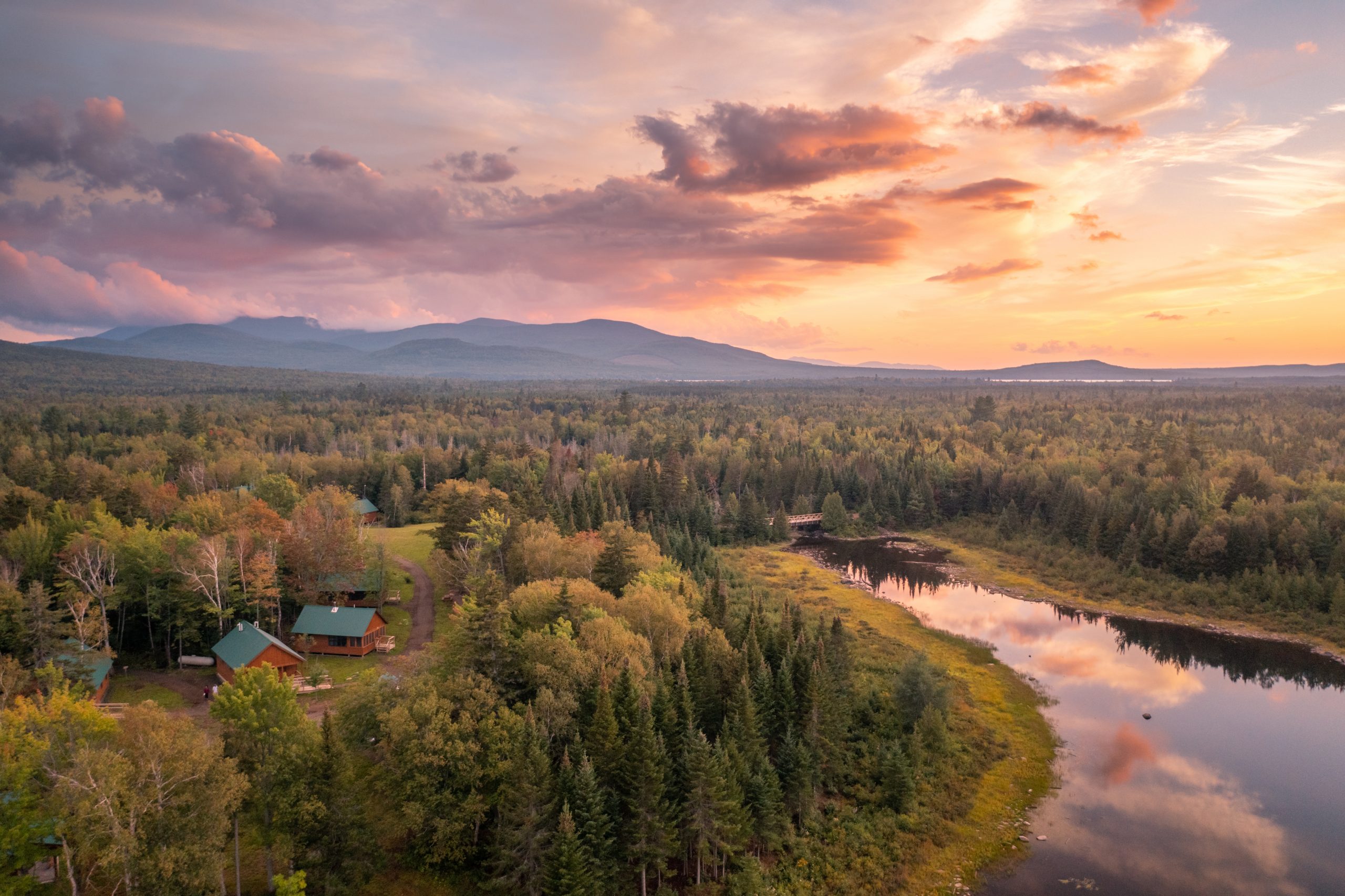 AMC Medawisla Lodge and Cabins, Maine Woods. Photo by Jamie Malcolm Brown. sunset photo of Medawisla Lodge & Cabins and surrounding area.
