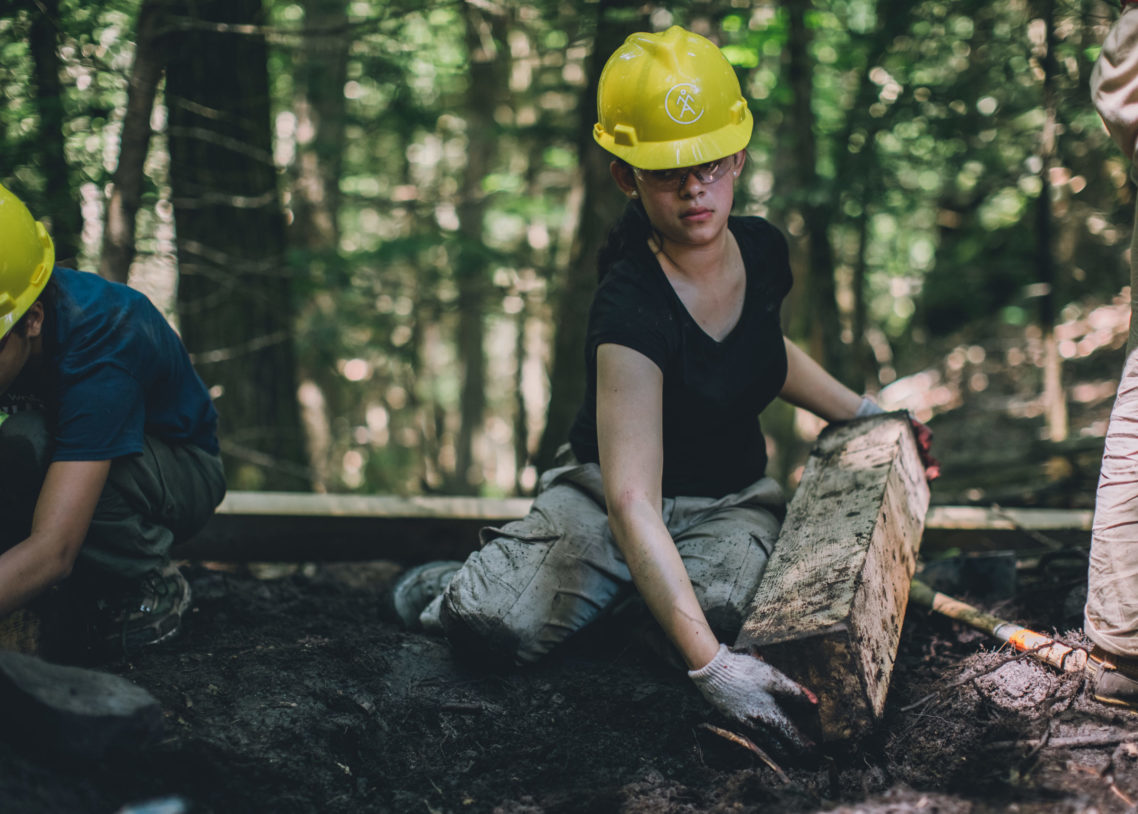 Jun. 26, 2019. Bay Circuit Trail, Boxford, Massachusetts-- A YOP trail crew. Volunteers are in yellow helmets and professional trail crew members are in blue and white helmets. Photo by Paula Champagne. Paula Champagne